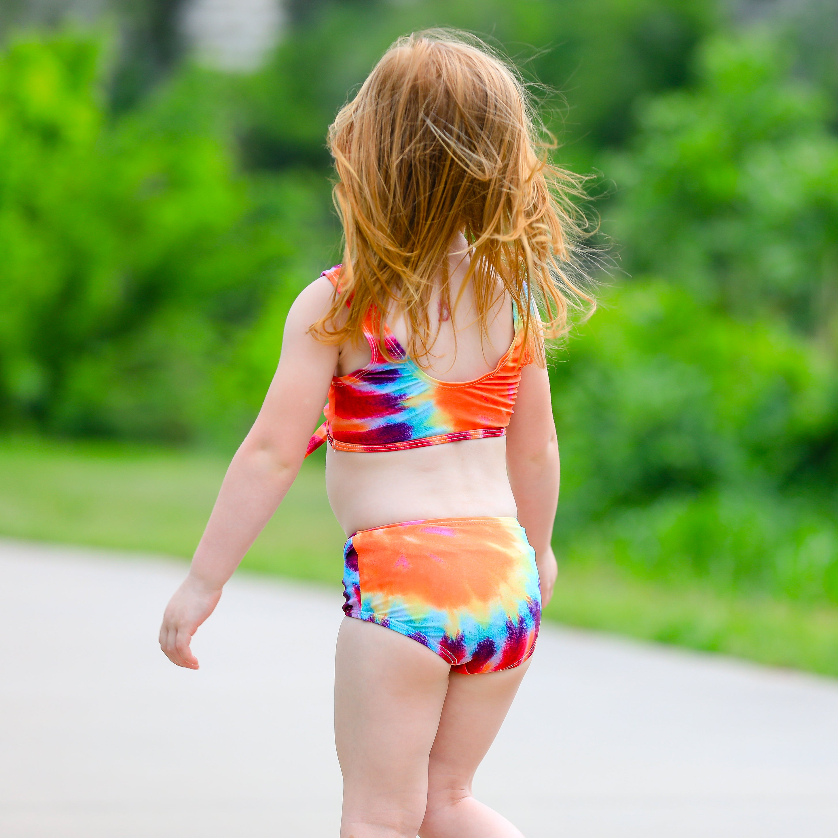 AL Limited Girls 2 piece Tie Dye Tankini Swimsuit featuring a rainbow swirl design with a tie knot tank top and high-waisted bottoms.